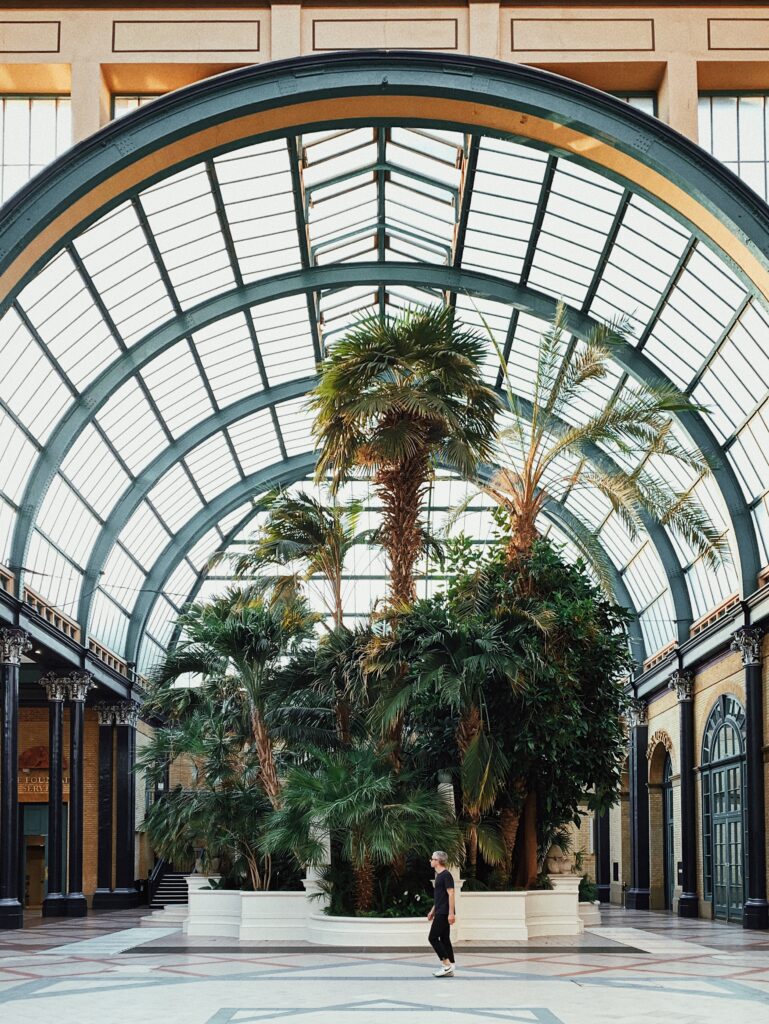 A man walking near tall trees inside the National Museum in Riyadh during the 'Our Riyadh: Culture, Curated' exhibition.
