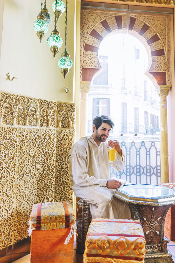 Man sitting in a traditional Arab restaurant, symbolizing the spiritual peace of staying near Masjid al-Nabawi.
